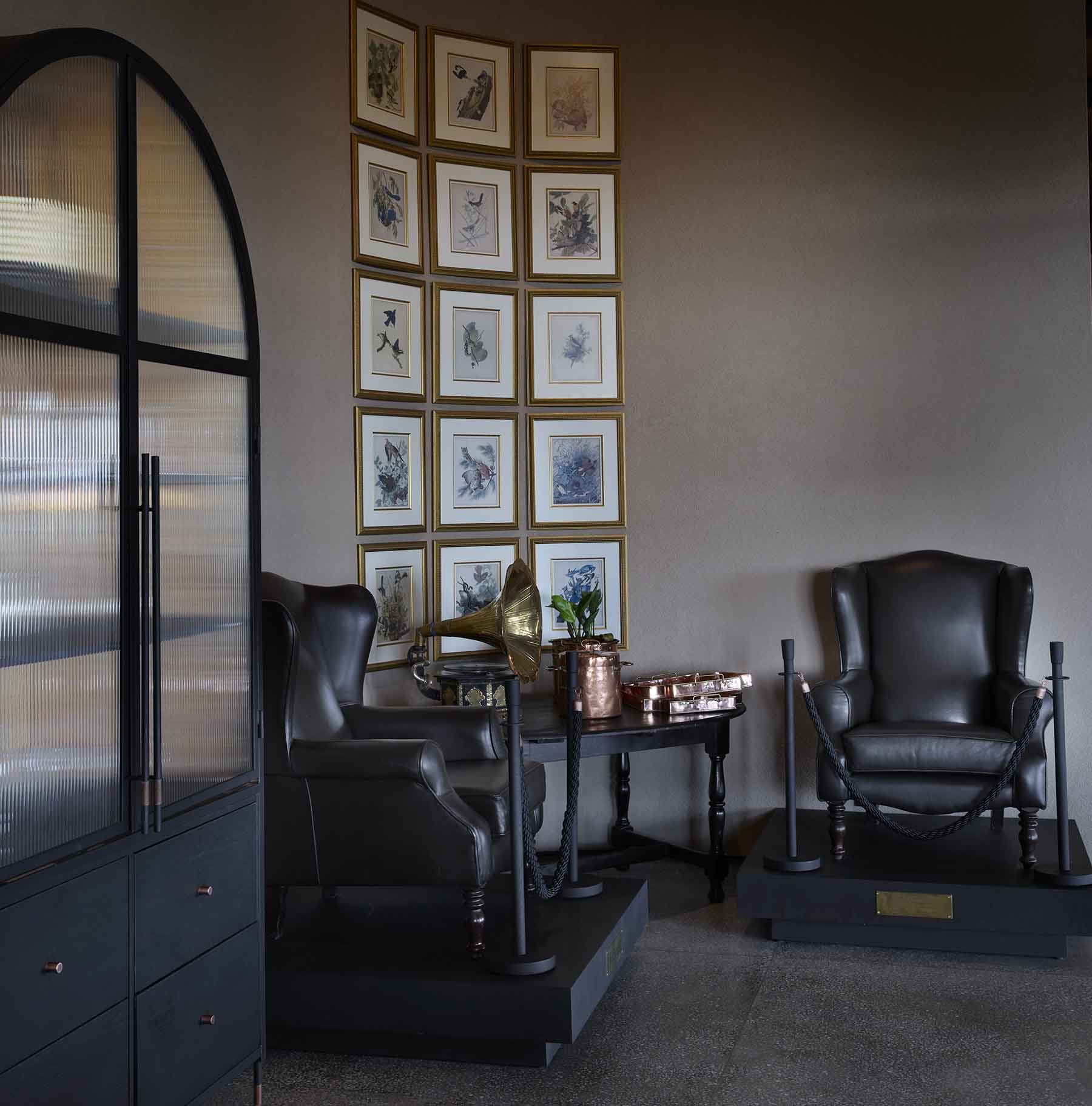 Dr Kaunda's two leather armchairs, kept at Chichele beneath a wall of framed bird prints