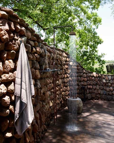 An outdoor stone shower in the bush